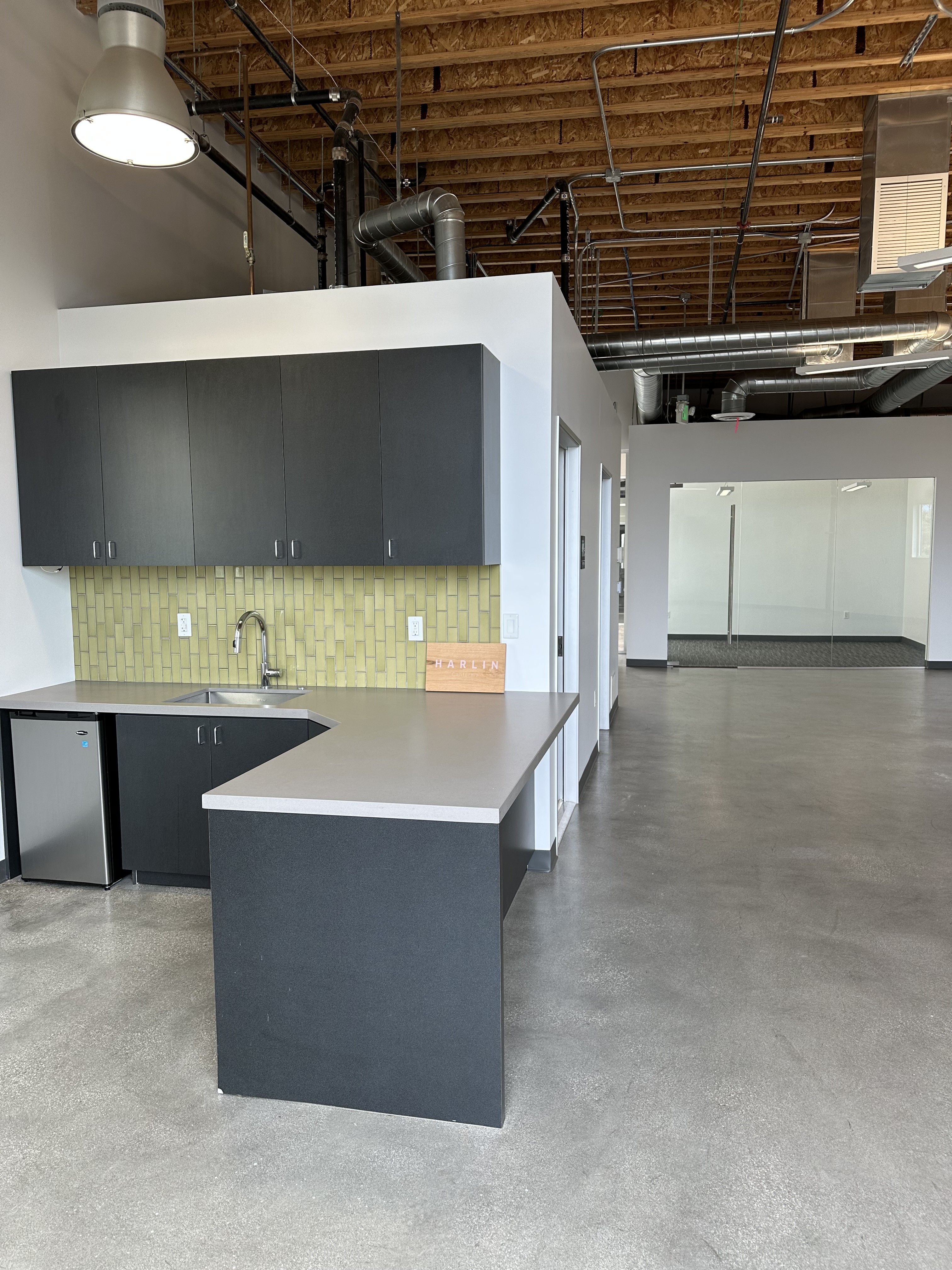Building 2 kitchen with green tile backsplash